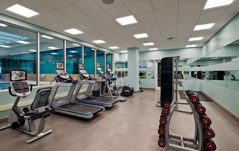 Fitness room with treadmills, elliptical machine, exercise bike and free weights