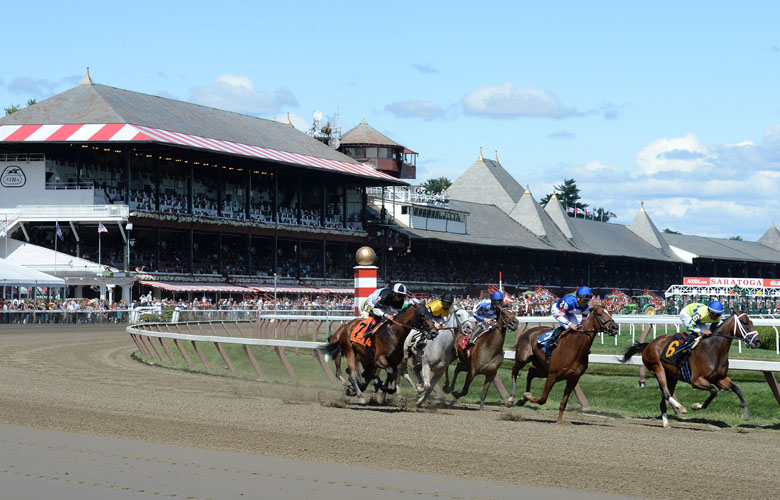 Thoroughbred horse race at Saratoga Race Course with Grandstand in the background